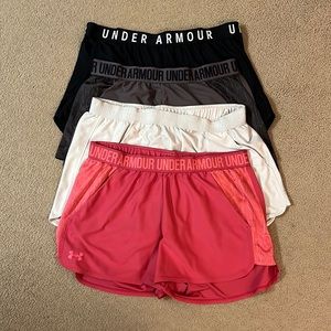 Bundle of 4 Under Armour Athletic Shorts in Pink, white, purple, and black.